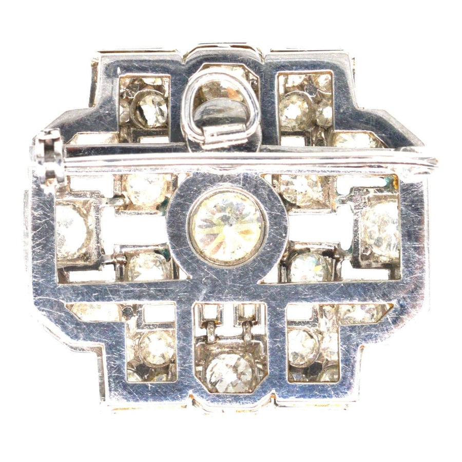 Art Deco platinum brooch featuring 7 carats of diamonds, geometric design with central stone, elegant vintage jewelry