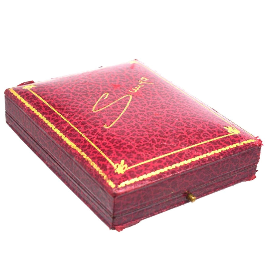 Red leather jewelry case with gold detailing, perfect for storing vintage Art Deco jewelry.