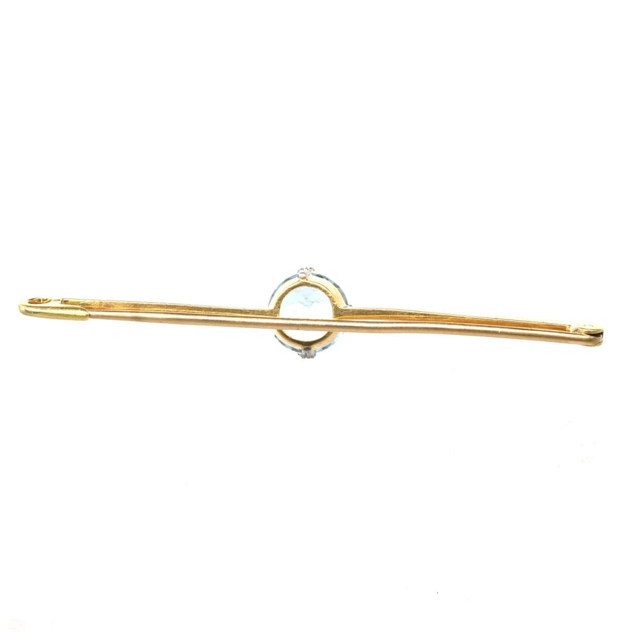 Art Deco platinum and 15ct gold bar brooch featuring blue aquamarine, showcasing unique historical charm.