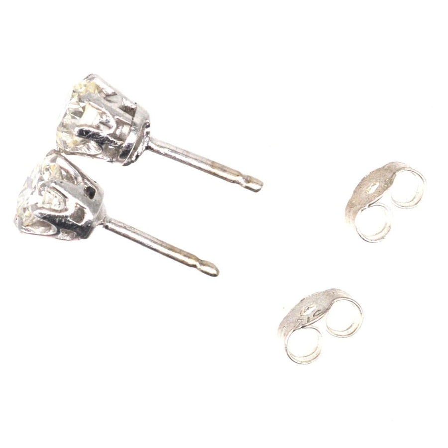 Art Deco platinum diamond stud earrings showcasing half-carat diamonds, perfect for formal and casual events.