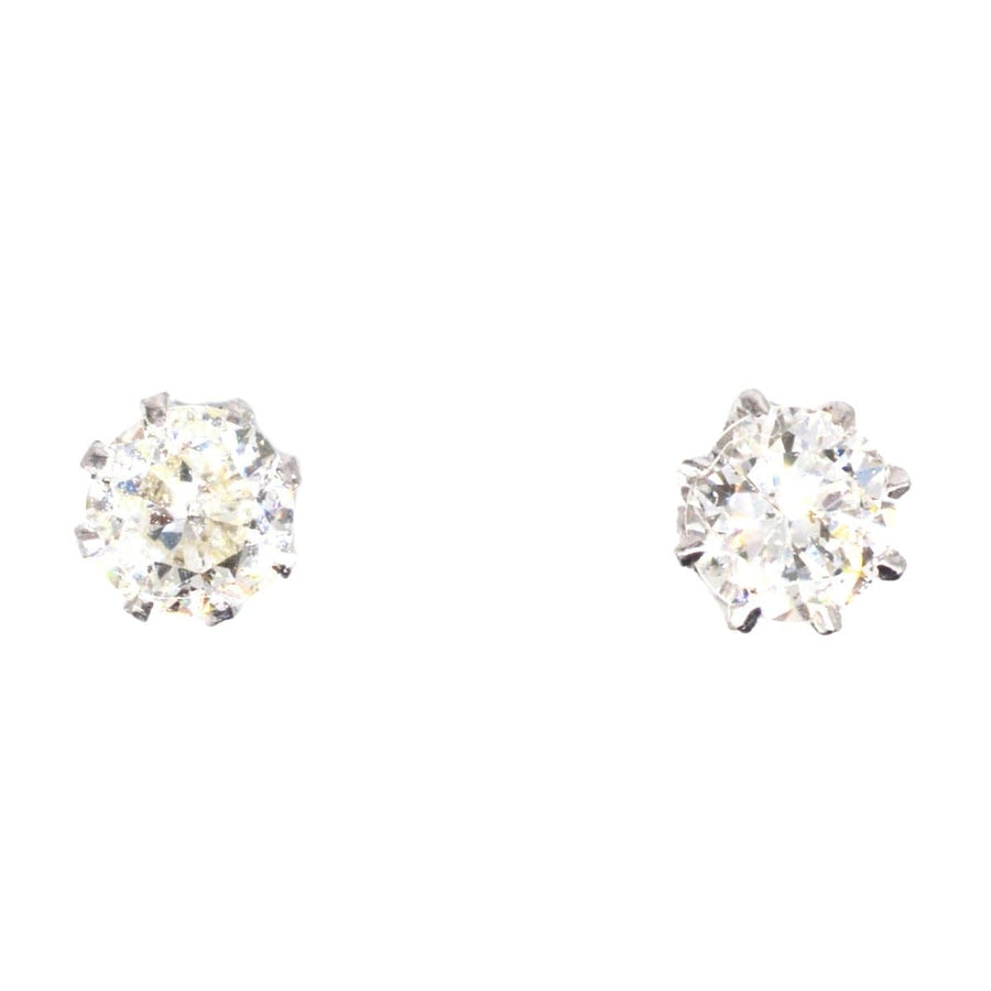 Art Deco platinum diamond stud earrings, 0.5 carats each, elegant for formal and casual occasions.