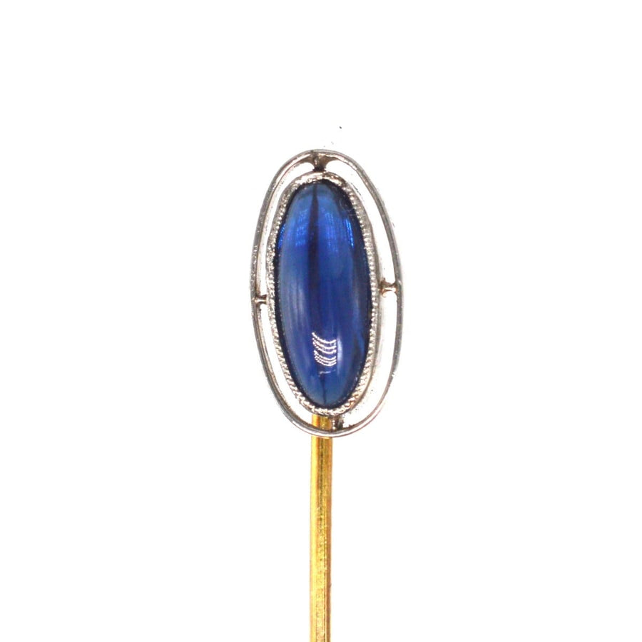 Art Deco platinum tie pin featuring a blue sapphire set in an open circular band, ideal for gifts and formal attire.