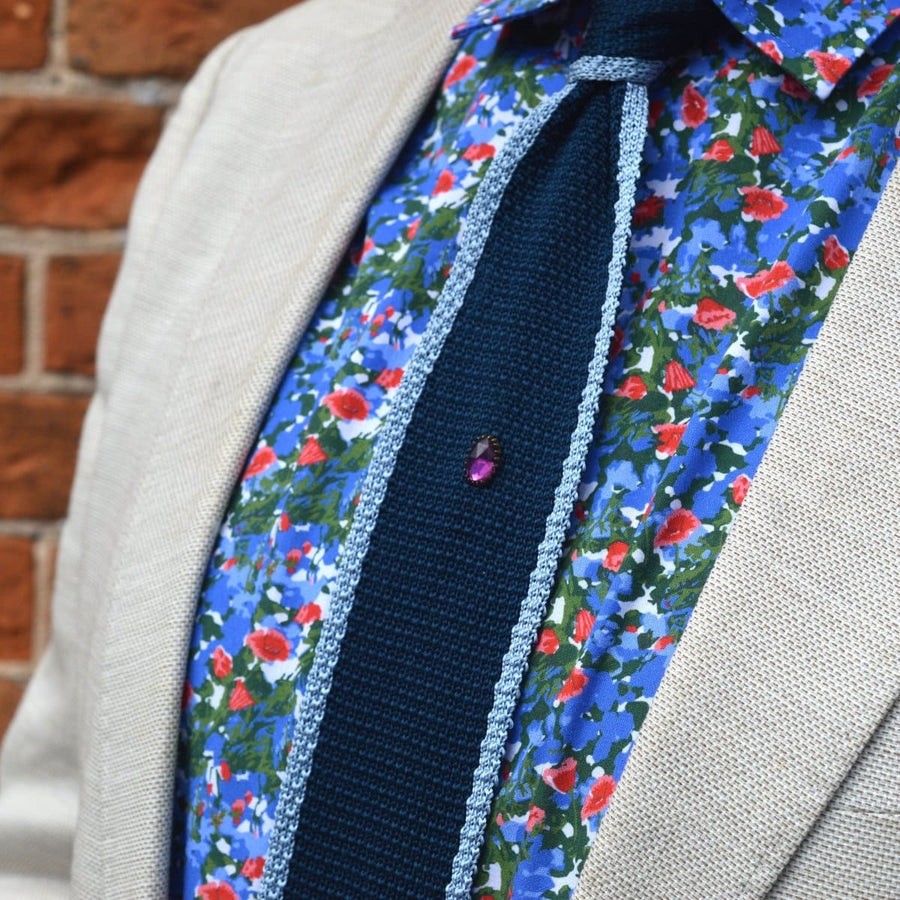 Art Deco purple rose cut paste tie pin on a colorful floral shirt and dark tie, enhancing classic menswear style.