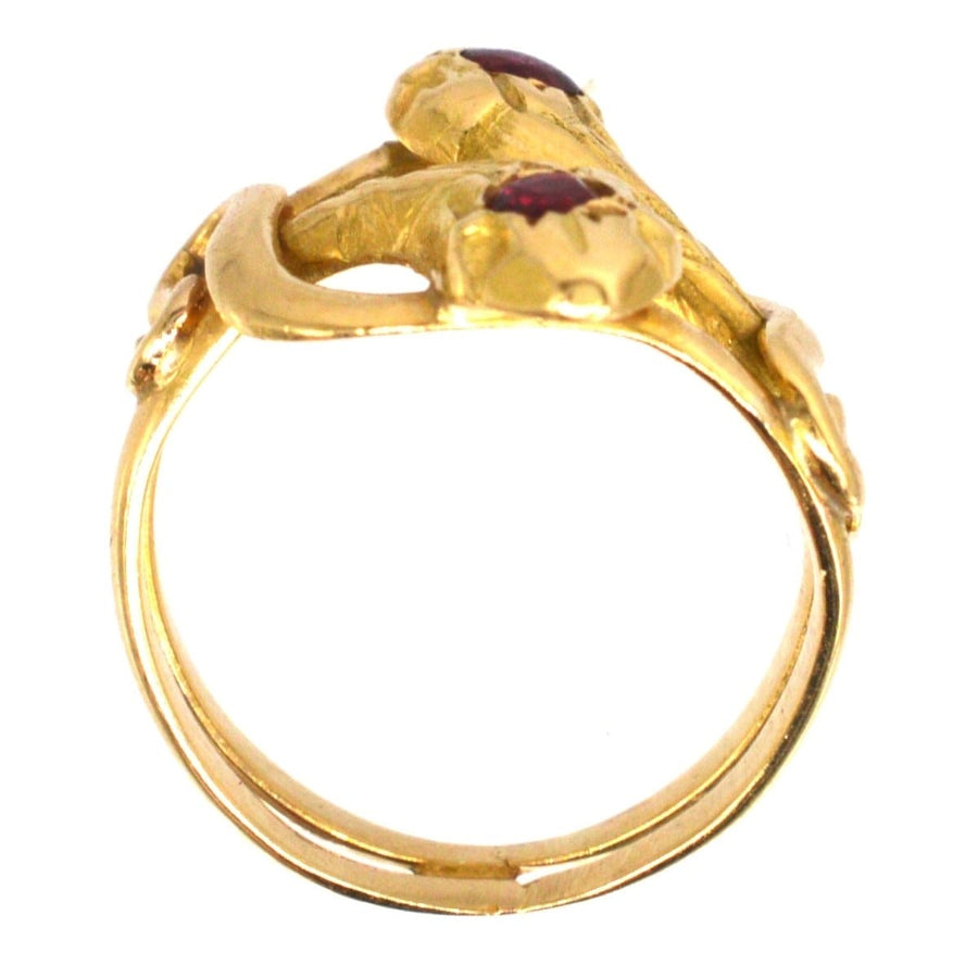 Antique French 18ct gold double snake ring featuring ruby and garnet, symbolizing eternal love.