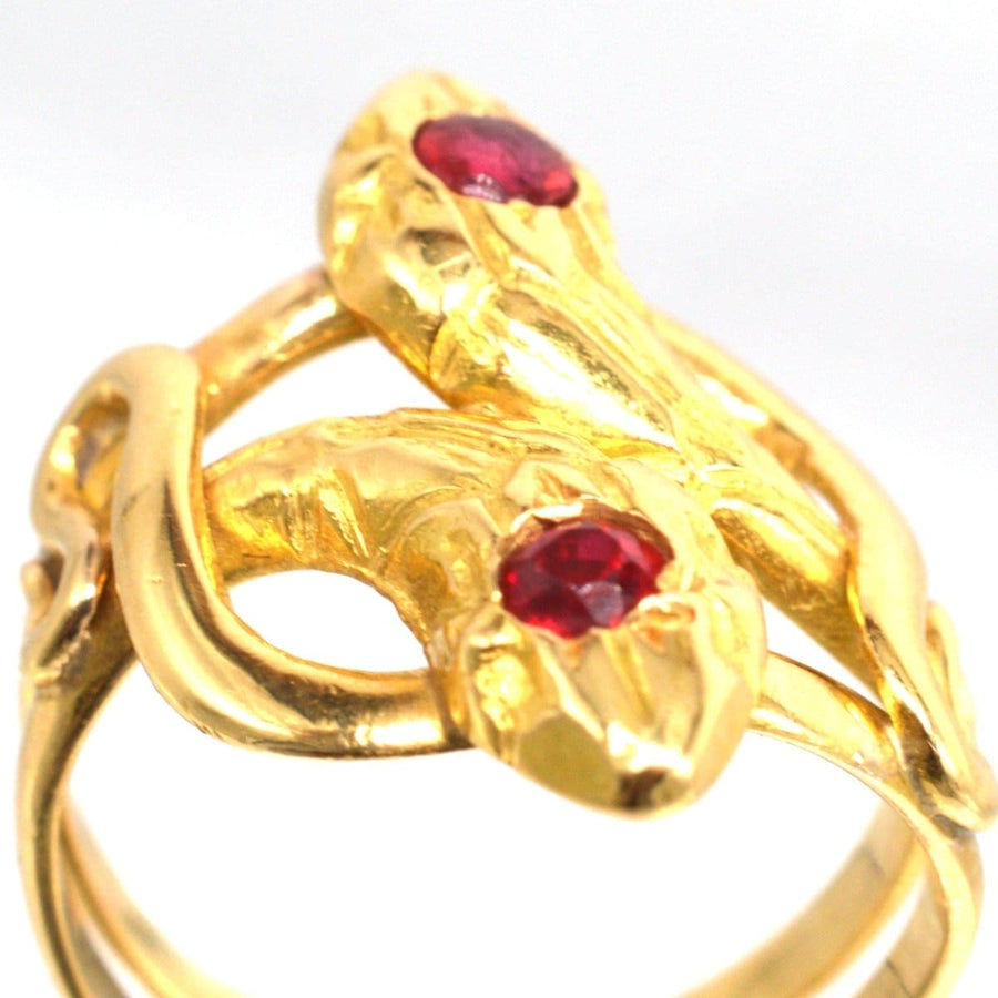 Antique French 18ct gold double snake ring with ruby and garnet, symbolizing eternal love.