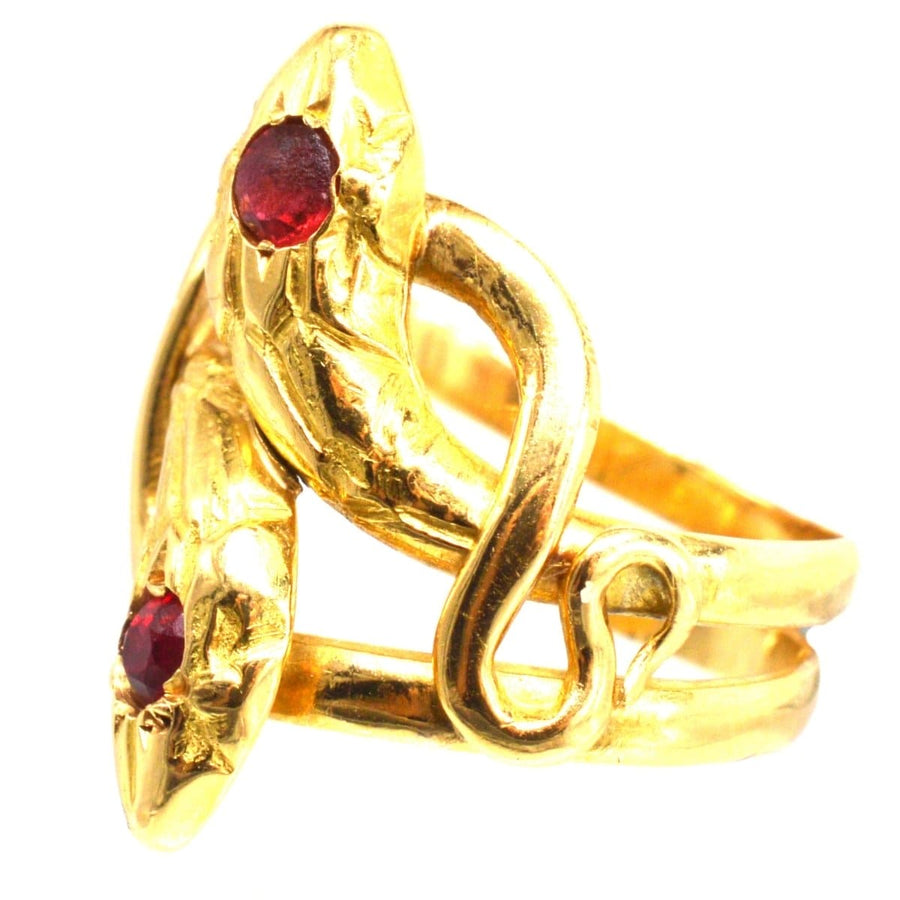 Antique French 18ct gold double snake ring with ruby and garnet, symbolizing eternal love and commitment.