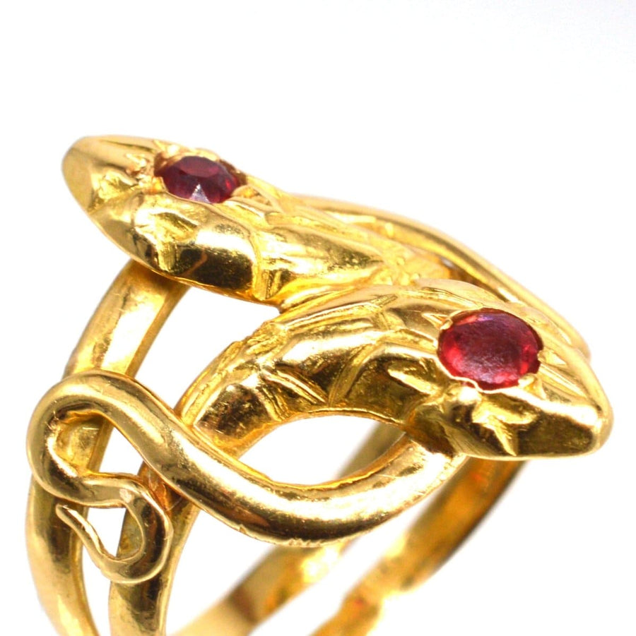 Belle Epoque antique 18ct gold double snake ring with ruby and garnet, symbolizing eternal love.