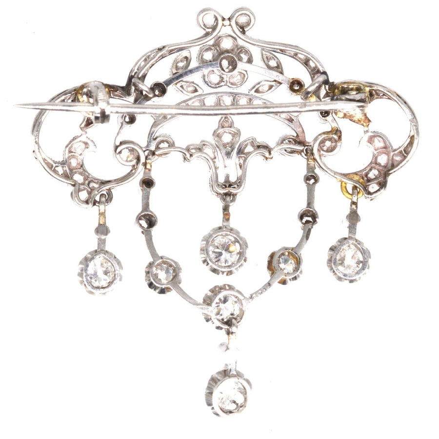 Belle Epoque 18ct white gold diamond drop brooch with floral motifs and elegant dangling diamonds.