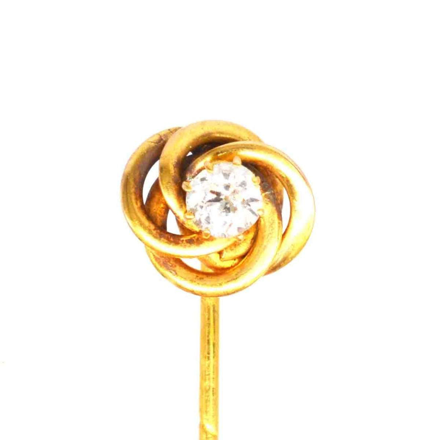 Early 20th century 14ct gold tie pin featuring a diamond in a knot design, symbolizing strength and eternity.