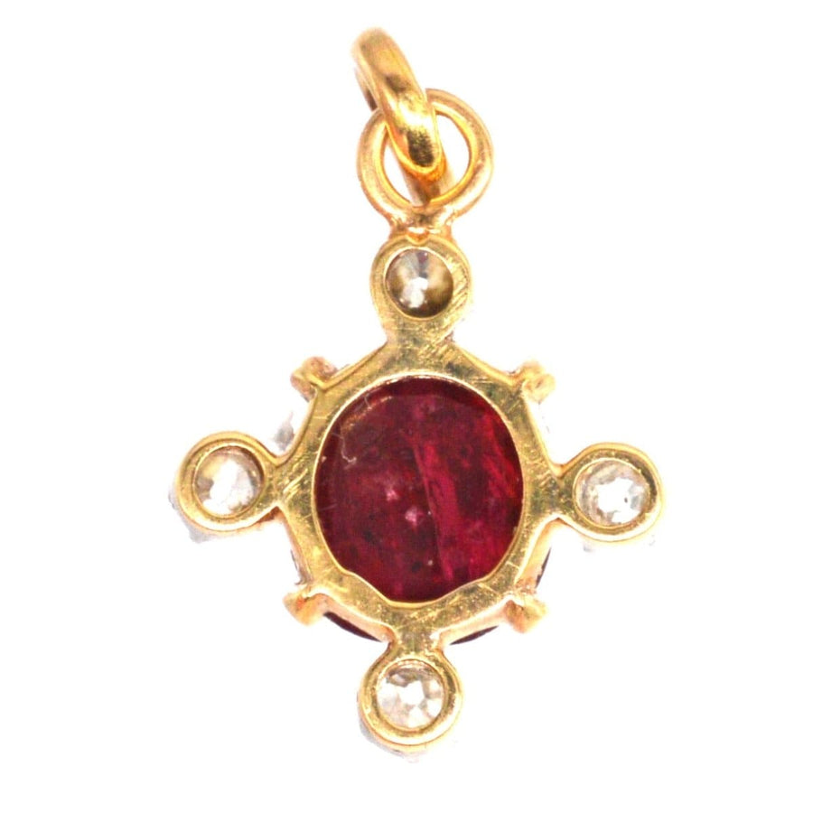 Early 20th century 18ct gold pendant featuring a cabochon ruby and four diamonds, showcasing Belle Epoque style.