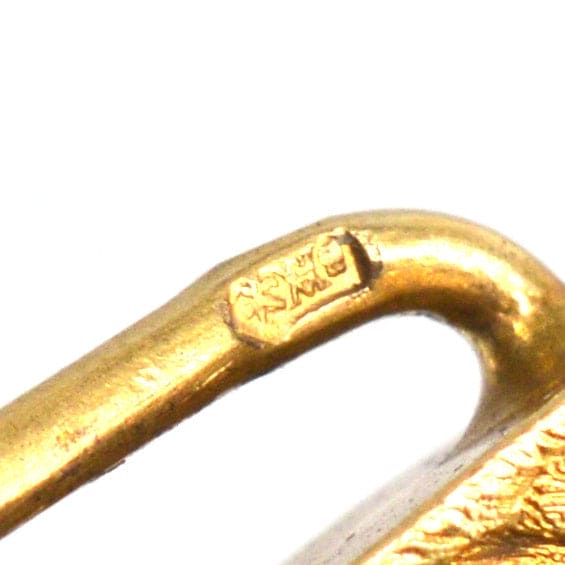 Close-up of 14ct gold tie pin showing detailed hallmark and craftsmanship.