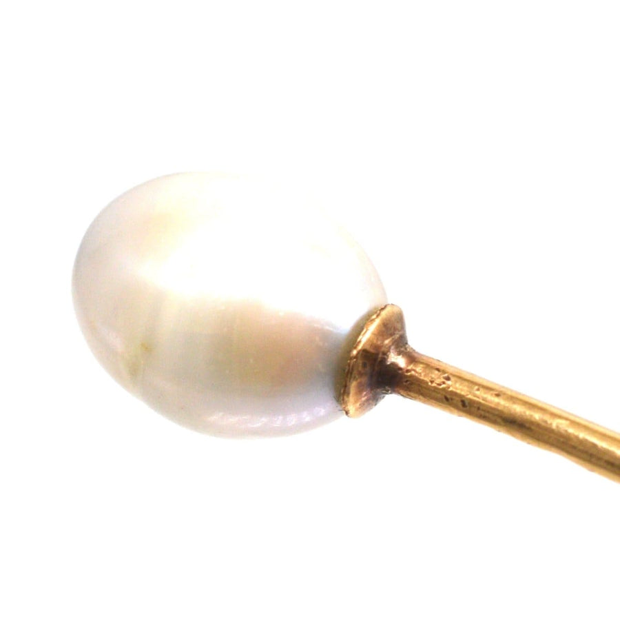 Close-up of a natural pearl tie pin from the early 20th century, featuring a 14ct gold base.