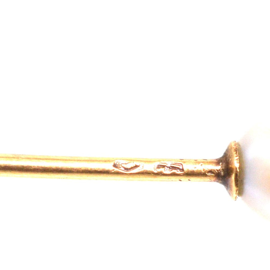 Close-up of 14ct gold tie pin with a natural pearl, showcasing vintage craftsmanship from the early 20th century.