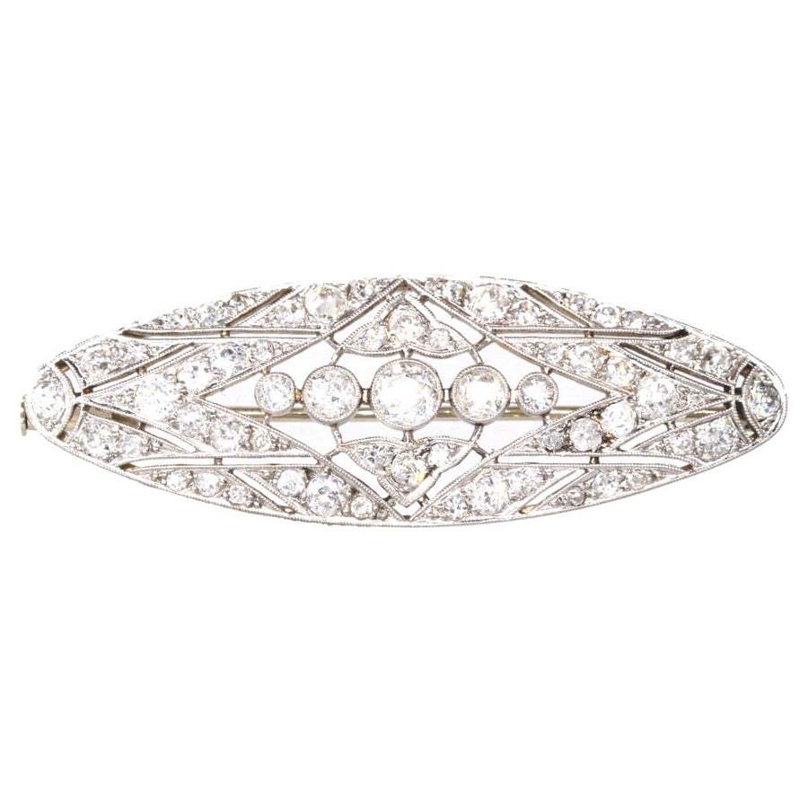 Early 20th Century geometric platinum and gold diamond brooch, showcasing stunning craftsmanship and 1.6 carats of diamonds.