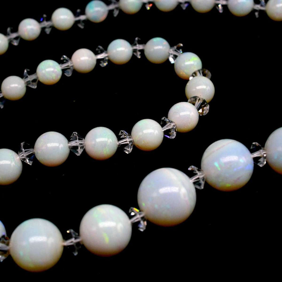 Early 20th century graduated opal bead necklace with luminous rock crystal spacers.