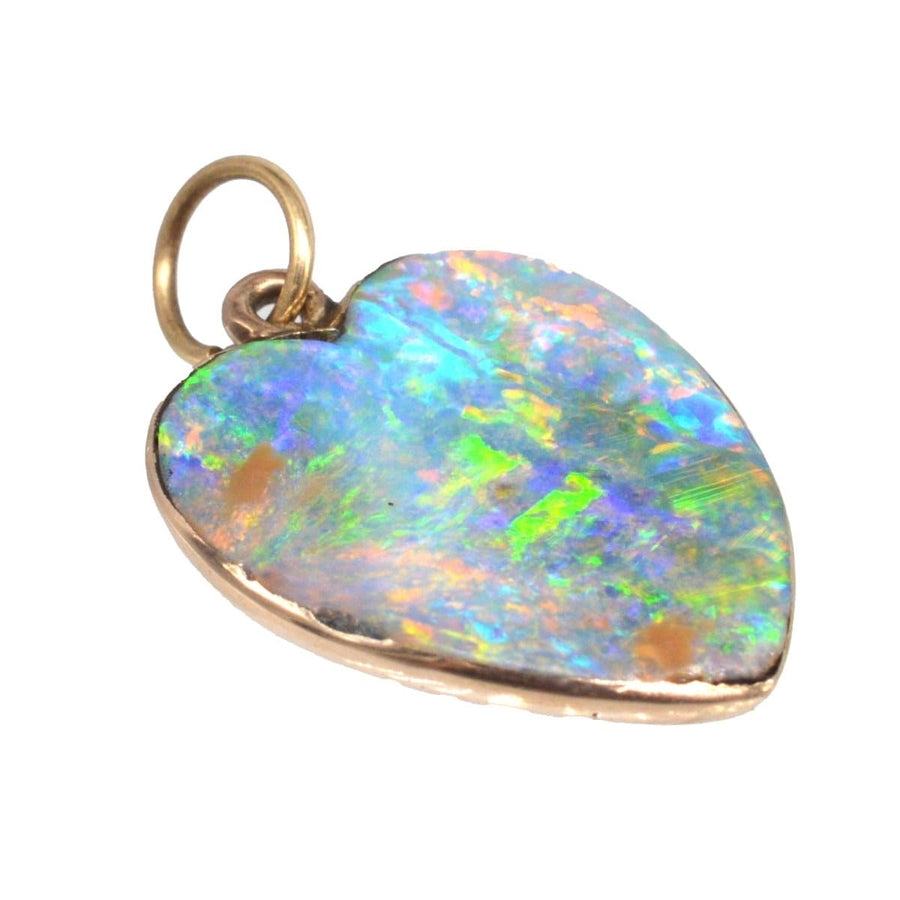 Edwardian 15ct gold heart pendant featuring a stunning black opal, perfect for antique jewelry collections.