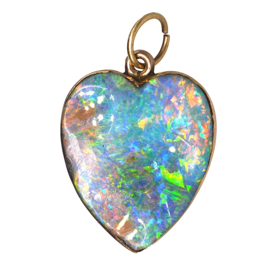 Edwardian 15ct gold heart pendant featuring a large, colorful black opal, perfect for antique jewelry collections.
