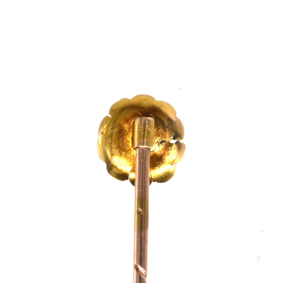 Edwardian 15ct gold flower tie pin featuring a curled petal design and diamond accent, perfect for elegant attire.