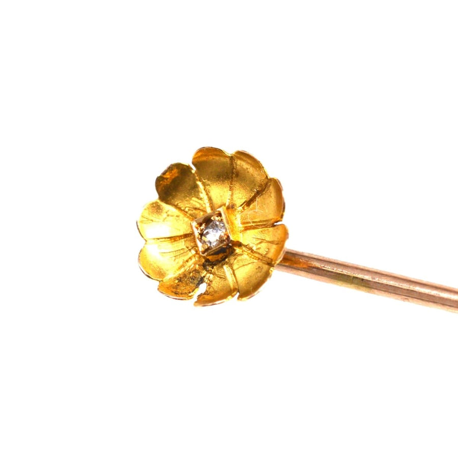Edwardian 15ct gold flower tie pin with diamond center and curled petals, perfect for elegant attire.