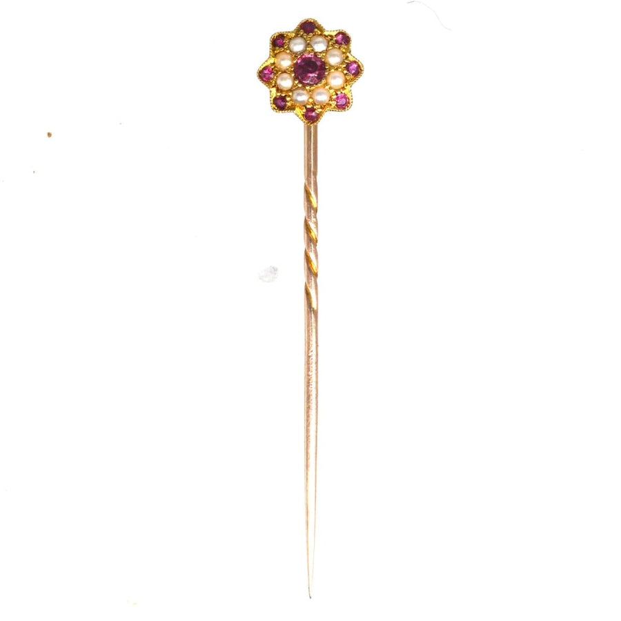 Elegant Edwardian 15ct gold tie pin designed as a flower with garnets and seed pearls, perfect for enhancing a silk tie.