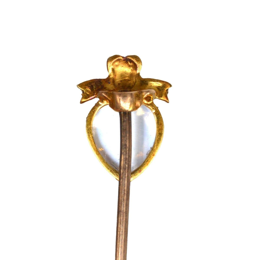Edwardian 15ct gold moonstone heart pin with ruby and seed pearl bow detail.