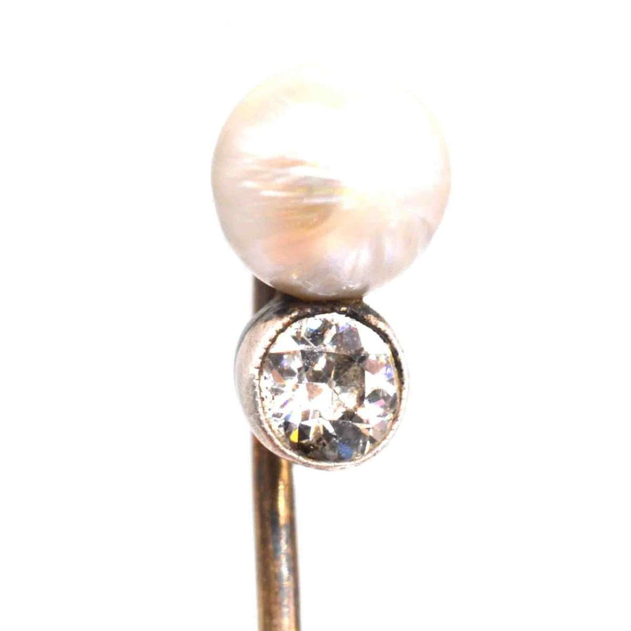 Edwardian 15ct gold pin with natural pearl and half-carat diamond, symbolizing elegance and sophistication.