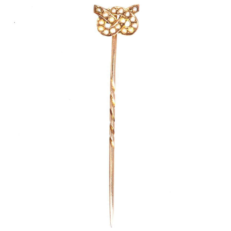 Edwardian 15ct gold Stafford knot tie pin featuring natural split pearls, embodying a classic design from the early 1900s.