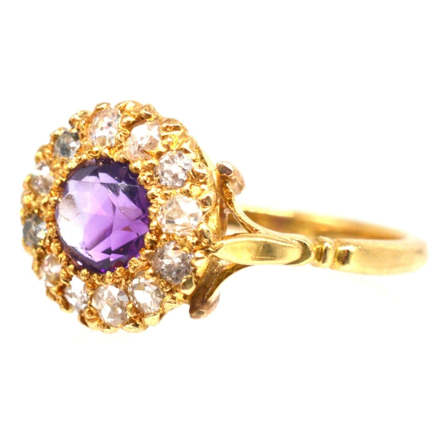 Edwardian 18ct gold amethyst and diamond cluster ring with a vibrant purple stone and sparkling diamond accents.