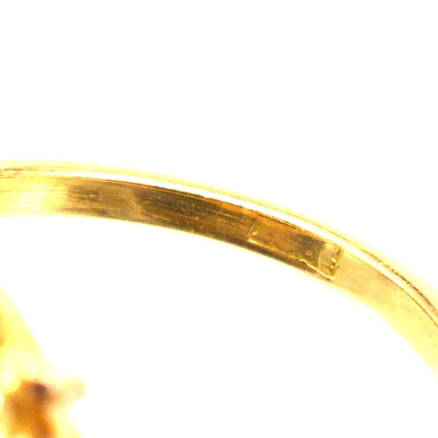 Close-up view of the band of an Edwardian 18ct gold amethyst and diamond cluster ring showing its intricate detailing.