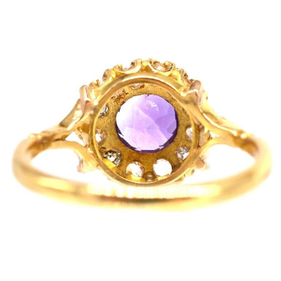 Edwardian 18ct gold amethyst and diamond cluster ring with intricate design and purple gemstone.