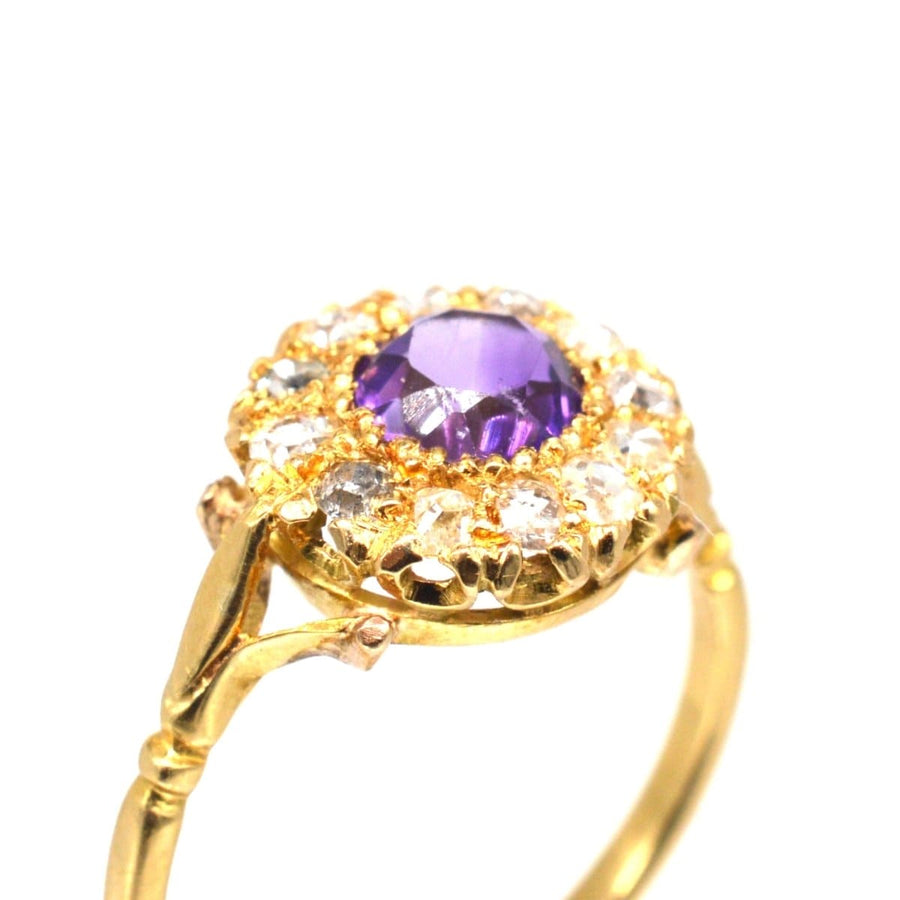 Edwardian 18ct gold cluster ring with amethyst and diamond, featuring a floral design and vintage charm.