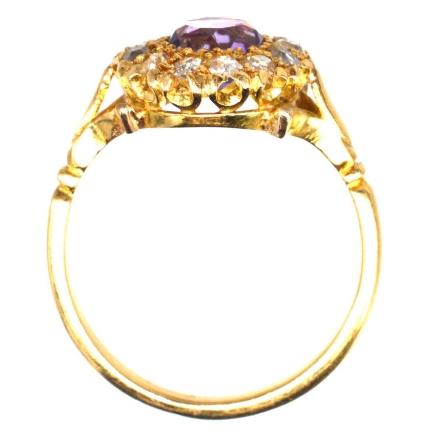 Edwardian 18ct gold ring featuring a central amethyst and diamond cluster design, showcasing classic elegance.
