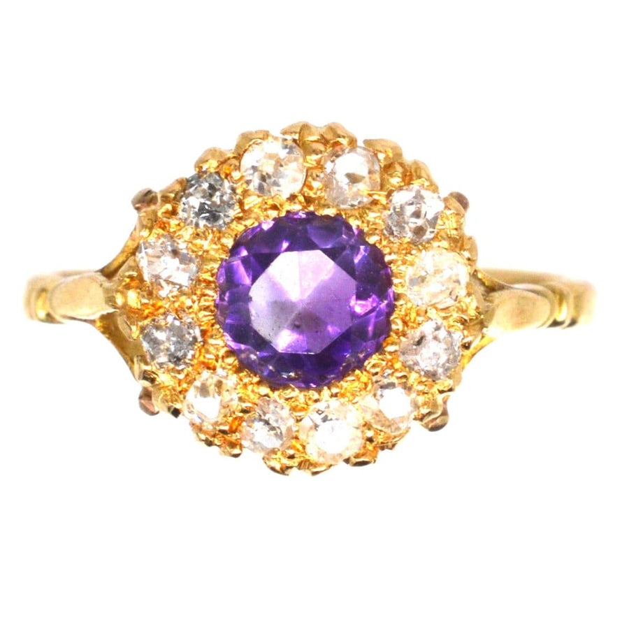 Edwardian 18ct gold cluster ring featuring a central amethyst surrounded by sparkling diamonds.