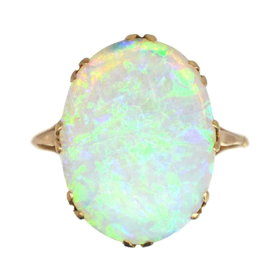 Edwardian 18ct gold large opal ring showcasing vivid green and blue color play, capturing elegance and grace of early 20th century.