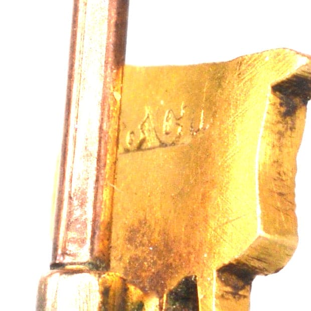 Close-up of the hallmark on an Edwardian 18ct Gold Britannia Tie Pin highlighting intricate details and craftsmanship.