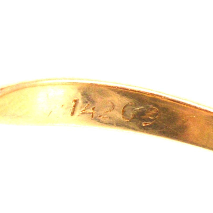 Close-up of the interior engraving showing the number 14269 on a gold ring.