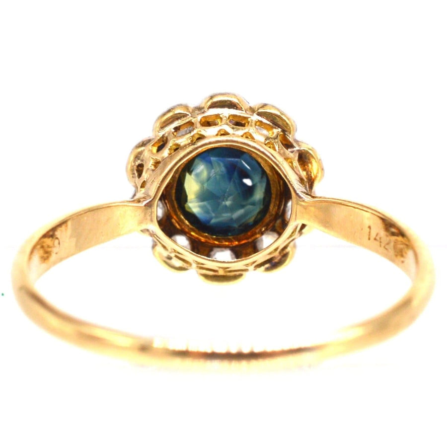 Elegant Edwardian 18ct gold cluster ring featuring teal sapphire and diamond accents.