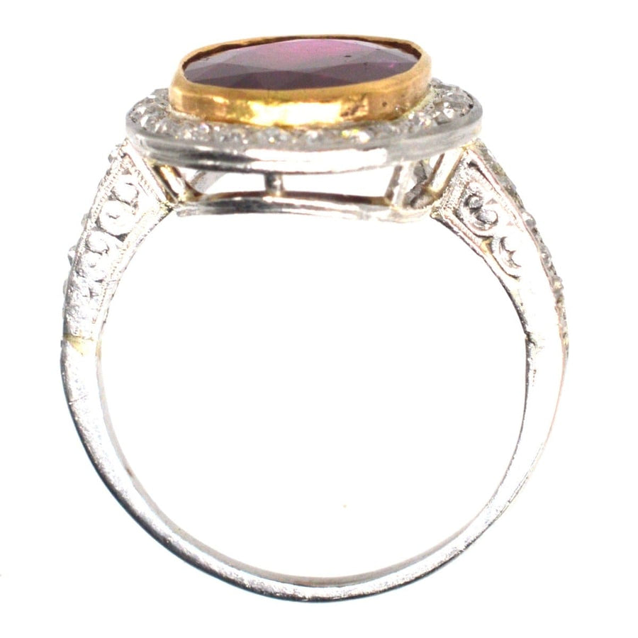 Edwardian 18ct white gold ring featuring a large Burma ruby and diamond cluster, showcasing vintage elegance.