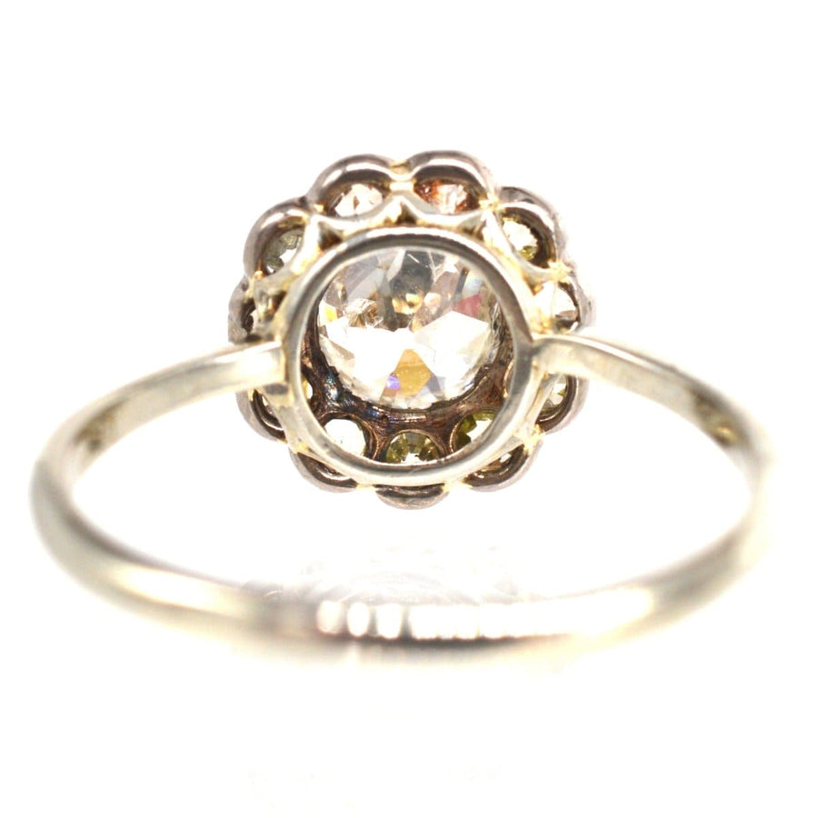 Edwardian 18ct white gold diamond cluster ring featuring a large old mine cut diamond center.