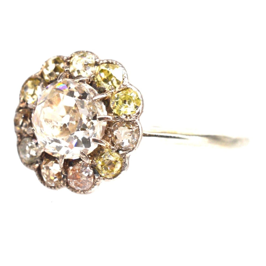 Edwardian 18ct white gold ring featuring a large old mine cut diamond cluster with tinted diamonds.