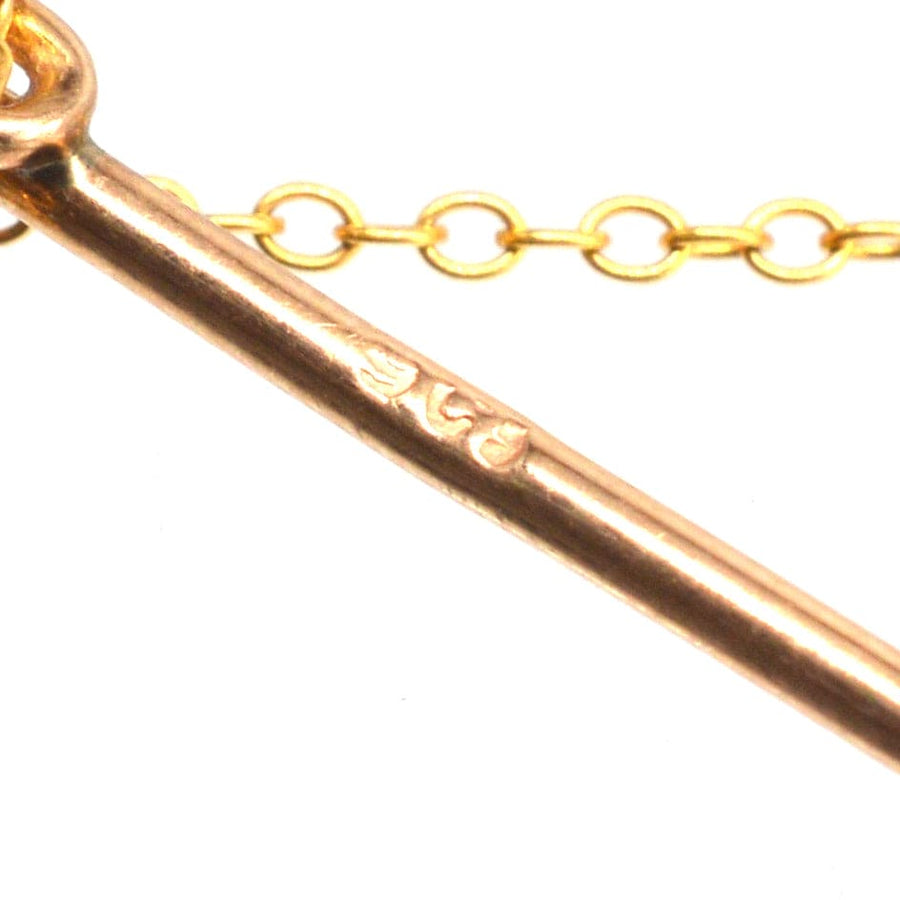Close-up of Edwardian 9ct gold tie pin highlighting hallmark and chain details with pearls.