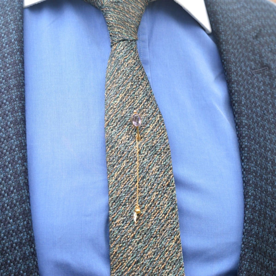 9ct gold amethyst tie pin with freshwater pearls styled on a tie, showcasing elegance and versatility in fashion.