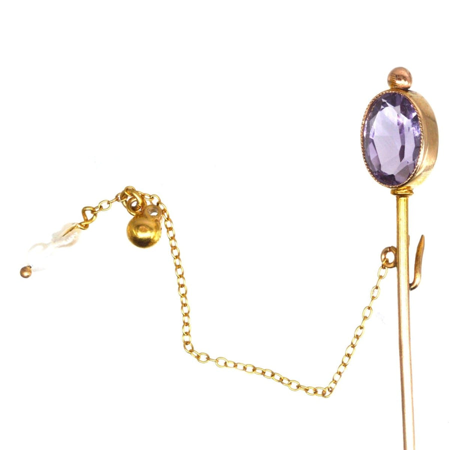 Edwardian 9ct gold tie pin featuring an oval amethyst and freshwater pearls, showcasing elegance and versatility.