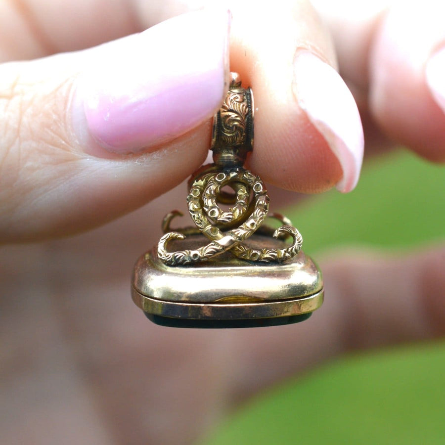 Vintage Edwardian 9ct gold locket seal pendant with embossed swirl knot design and bloodstone.