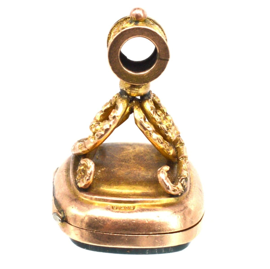 Edwardian 9ct gold opening locket seal pendant with bloodstone, featuring intricate embossed swirl knot design.