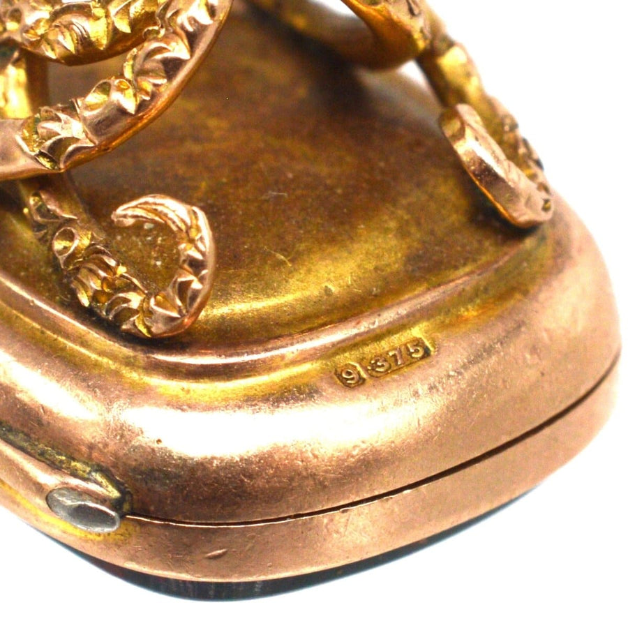 Detail of Edwardian 9ct gold pendant seal with embossed swirl design and bloodstone base.