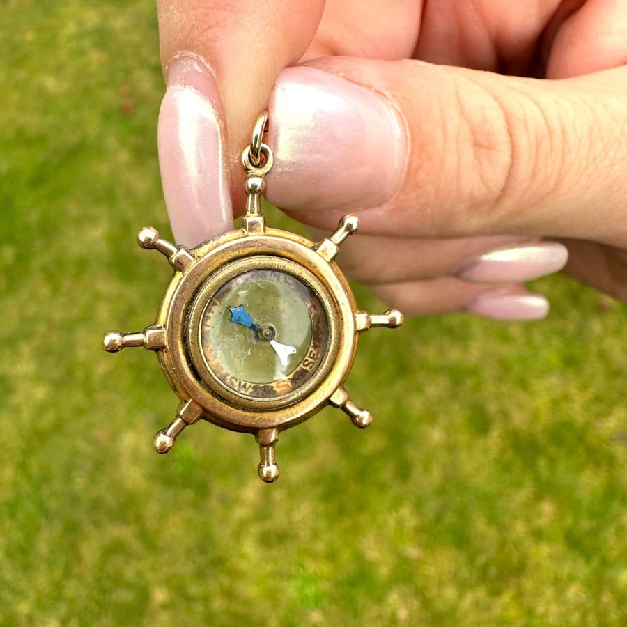 Edwardian 9ct gold ship wheel compass pendant with spinning needle, perfect nautical gift.