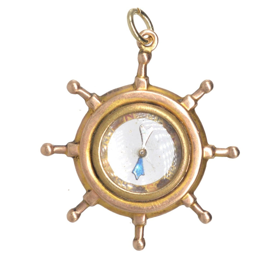 Edwardian 9ct gold ship wheel compass pendant with spinning needle, ideal nautical gift for guidance.