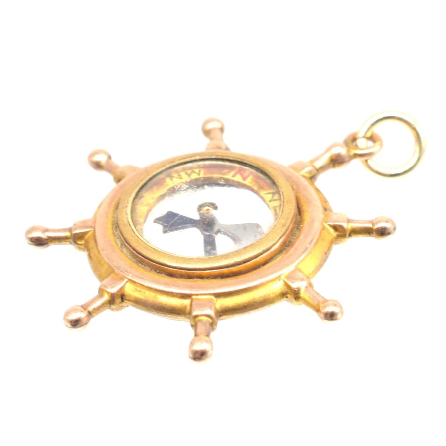 Edwardian 9ct gold ship wheel compass pendant with spinning needle, perfect nautical gift.