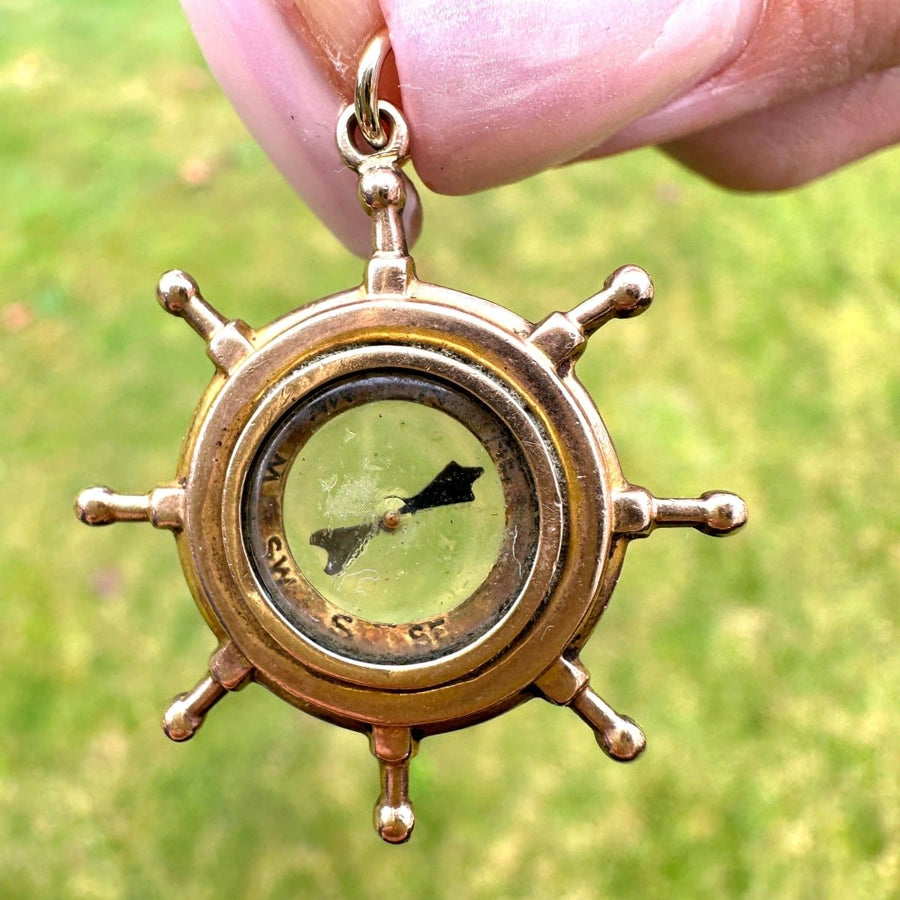 Edwardian 9ct gold ship wheel compass pendant with spinning needle, perfect nautical gift.
